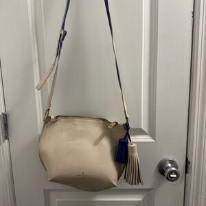 kate spade cream leather crossbody with blue tassel accents